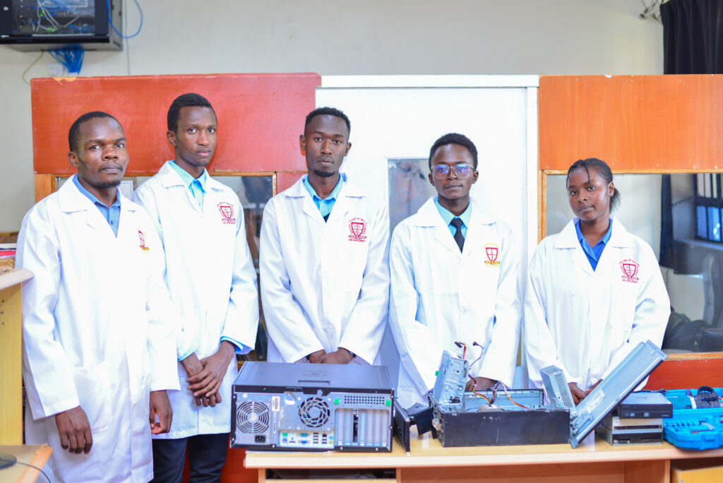 Students using desktop computers in the college ICT Hub during a practical computer training session in a modern learning environment.
